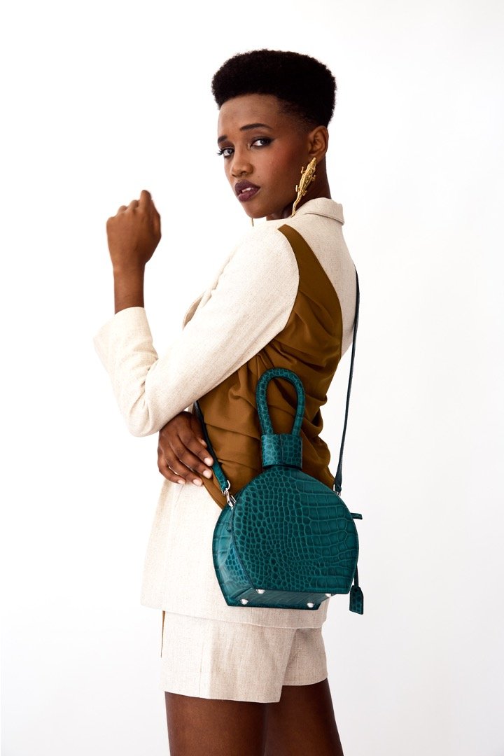Photoshoot of ATENA EMERALD CROC PURSE-SLING BAG, a green bag, green handbag, with croc look from MDLR