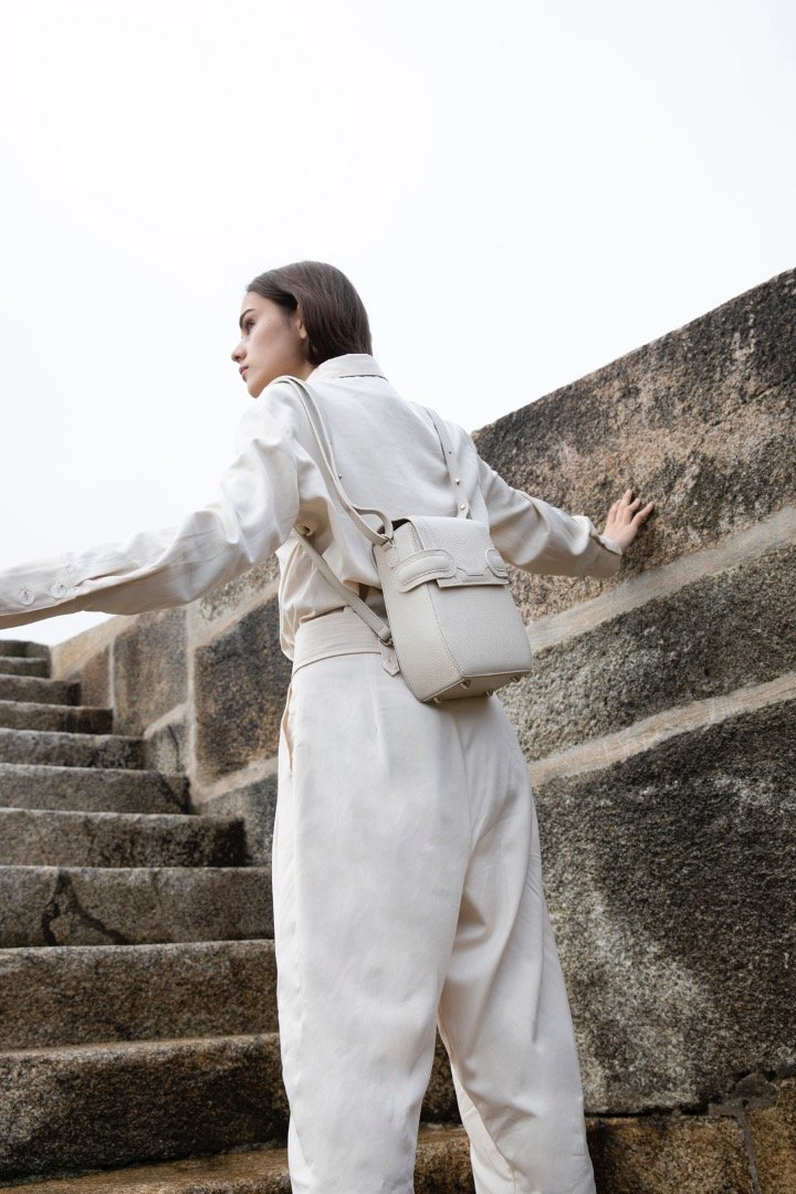 A woman in white with OCTAVIO RIS 4 WAY BACKPACK, a cute cream backpack with fashionable look and feel by MDLR