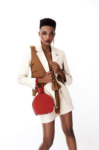 A photoshoot of ATENA ROSSO LIZARD PURSE-SLING BAG, a hot red bag, hot red purse, with lizard look from MDLR
