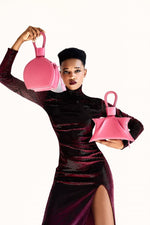 Load image into Gallery viewer, A photoshoot with ATENA PASSION PURSE-SLING BAG, a hot pink bag, hot pink purse, with minimalist look from MDLR
