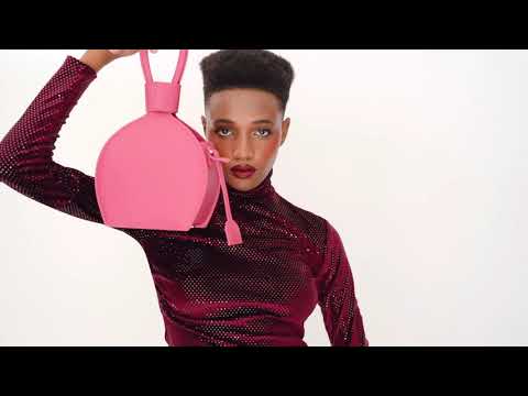 A studio videoshoot with ATENA PASSION PURSE-SLING BAG, a hot pink bag, hot pink purse, with minimalist look from MDLR